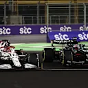 JEDDAH, SAUDI ARABIA - DECEMBER 05: Kimi Raikkonen of Finland driving the (7) Alfa Romeo Racing C41 Ferrari and Sebastian Vettel of Germany driving the (5) Aston Martin AMR21 Mercedes  during the F1 Grand Prix of Saudi Arabia at Jeddah Corniche Circuit on December 05, 2021 in Jeddah, Saudi Arabia. (Photo by Bryn Lennon - Formula 1/Formula 1 via Getty Images)
