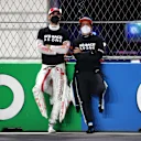 JEDDAH, SAUDI ARABIA - DECEMBER 05: Antonio Giovinazzi of Italy and Alfa Romeo Racing and Fernando Alonso of Spain and Alpine F1 Team talk on the grid before the F1 Grand Prix of Saudi Arabia at Jeddah Corniche Circuit on December 05, 2021 in Jeddah, Saudi Arabia. (Photo by Bryn Lennon - Formula 1/Formula 1 via Getty Images)