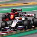 BARCELONA, SPAIN - MAY 08: Nikita Mazepin of Russia driving the (9) Haas F1 Team VF-21 Ferrari leads Carlos Sainz of Spain driving the (55) Scuderia Ferrari SF21 during final practice for the F1 Grand Prix of Spain at Circuit de Barcelona-Catalunya on May 08, 2021 in Barcelona, Spain. (Photo by Lars Baron/Getty Images)