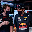 BARCELONA, SPAIN - MAY 08: Sergio Perez of Mexico and Red Bull Racing talks with an engineer in the garage during qualifying for the F1 Grand Prix of Spain at Circuit de Barcelona-Catalunya on May 08, 2021 in Barcelona, Spain. (Photo by Mark Thompson/Getty Images)