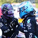 BARCELONA, SPAIN - MAY 08: Pole position qualifier Lewis Hamilton of Great Britain and Mercedes GP interacts with teammate and third placed qualifier Valtteri Bottas of Finland and Mercedes GP in parc ferme during qualifying for the F1 Grand Prix of Spain at Circuit de Barcelona-Catalunya on May 08, 2021 in Barcelona, Spain. (Photo by Emilio Morenatti - Pool/Getty Images)