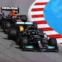 BARCELONA, SPAIN - MAY 09: Lewis Hamilton of Great Britain driving the (44) Mercedes AMG Petronas F1 Team Mercedes W12 leads Max Verstappen of the Netherlands driving the (33) Red Bull Racing RB16B Honda on track during the F1 Grand Prix of Spain at Circuit de Barcelona-Catalunya on May 09, 2021 in Barcelona, Spain. (Photo by Bryn Lennon/Getty Images)