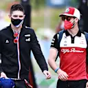 SPIELBERG, AUSTRIA - JUNE 25: Esteban Ocon of France and Alpine F1 Team and Antonio Giovinazzi of Italy and Alfa Romeo Racing talk in the Paddock before practice ahead of the F1 Grand Prix of Styria at Red Bull Ring on June 25, 2021 in Spielberg, Austria. (Photo by Mark Thompson/Getty Images)
