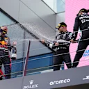 SPIELBERG, AUSTRIA - JUNE 27: Race winner Max Verstappen of Netherlands and Red Bull Racing, second placed Lewis Hamilton of Great Britain and Mercedes GP and third placed Valtteri Bottas of Finland and Mercedes GP celebrate on the podium during the F1 Grand Prix of Styria at Red Bull Ring on June 27, 2021 in Spielberg, Austria. (Photo by Darko Vojinovic - Pool/Getty Images)