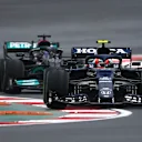 ISTANBUL, TURKEY - OCTOBER 10: Pierre Gasly of France driving the (10) Scuderia AlphaTauri AT02 Honda leads Lewis Hamilton of Great Britain driving the (44) Mercedes AMG Petronas F1 Team Mercedes W12 during the F1 Grand Prix of Turkey at Intercity Istanbul Park on October 10, 2021 in Istanbul, Turkey. (Photo by Dan Mullan/Getty Images)