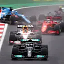 ISTANBUL, TURKEY - OCTOBER 10: Valtteri Bottas of Finland driving the (77) Mercedes AMG Petronas F1 Team Mercedes W12 leads Max Verstappen of the Netherlands driving the (33) Red Bull Racing RB16B Honda and the rest of the field as Fernando Alonso of Spain driving the (14) Alpine A521 Renault spins at the start during the F1 Grand Prix of Turkey at Intercity Istanbul Park on October 10, 2021 in Istanbul, Turkey. (Photo by Dan Istitene - Formula 1/Formula 1 via Getty Images)