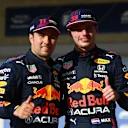 AUSTIN, TEXAS - OCTOBER 23: First place qualifier Max Verstappen of Netherlands and Red Bull Racing and third place qualifier Sergio Perez of Mexico and Red Bull Racing celebrate in parc ferme during qualifying ahead of the F1 Grand Prix of USA at Circuit of The Americas on October 23, 2021 in Austin, Texas. (Photo by Clive Mason - Formula 1/Formula 1 via Getty Images)