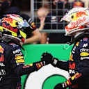 AUSTIN, TEXAS - OCTOBER 23: First place qualifier Max Verstappen of Netherlands and Red Bull Racing and third place qualifier Sergio Perez of Mexico and Red Bull Racing celebrate in parc ferme during qualifying ahead of the F1 Grand Prix of USA at Circuit of The Americas on October 23, 2021 in Austin, Texas. (Photo by Chris Graythen/Getty Images)