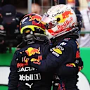 AUSTIN, TEXAS - OCTOBER 23: First place qualifier Max Verstappen of Netherlands and Red Bull Racing and third place qualifier Sergio Perez of Mexico and Red Bull Racing celebrate in parc ferme during qualifying ahead of the F1 Grand Prix of USA at Circuit of The Americas on October 23, 2021 in Austin, Texas. (Photo by Chris Graythen/Getty Images)
