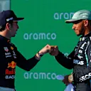AUSTIN, TEXAS - OCTOBER 23: Second place qualifier Lewis Hamilton of Great Britain and Mercedes GP and third place qualifier Sergio Perez of Mexico and Red Bull Racing celebrate in parc ferme during qualifying ahead of the F1 Grand Prix of USA at Circuit of The Americas on October 23, 2021 in Austin, Texas. (Photo by Jared C. Tilton/Getty Images)