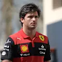 ABU DHABI, UNITED ARAB EMIRATES - NOVEMBER 18: Carlos Sainz of Spain and Ferrari walks in the paddock  prior to practice ahead of the F1 Grand Prix of Abu Dhabi at Yas Marina Circuit on November 18, 2022 in Abu Dhabi, United Arab Emirates. (Photo by Rudy Carezzevoli/Getty Images)