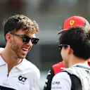 ABU DHABI, UNITED ARAB EMIRATES - NOVEMBER 20: Pierre Gasly of France and Scuderia AlphaTauri, Yuki Tsunoda of Japan and Scuderia AlphaTauri and Charles Leclerc of Monaco and Ferrari talk on the drivers parade prior to the F1 Grand Prix of Abu Dhabi at Yas Marina Circuit on November 20, 2022 in Abu Dhabi, United Arab Emirates. (Photo by Rudy Carezzevoli/Getty Images)