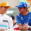 ABU DHABI, UNITED ARAB EMIRATES - NOVEMBER 20: Lando Norris of Great Britain and McLaren talks with Fernando Alonso of Spain and Alpine F1 on the drivers parade prior to the F1 Grand Prix of Abu Dhabi at Yas Marina Circuit on November 20, 2022 in Abu Dhabi, United Arab Emirates. (Photo by Bryn Lennon - Formula 1/Formula 1 via Getty Images)