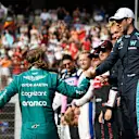 ABU DHABI, UNITED ARAB EMIRATES - NOVEMBER 20: Sebastian Vettel of Germany and Aston Martin F1 Team is greeted by Nicholas Latifi of Canada and Williams  as they prepare for the F1 2022 End of Year photo prior to the F1 Grand Prix of Abu Dhabi at Yas Marina Circuit on November 20, 2022 in Abu Dhabi, United Arab Emirates. (Photo by Rudy Carezzevoli/Getty Images)