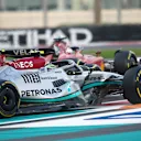ABU DHABI, UNITED ARAB EMIRATES - NOVEMBER 20: Lewis Hamilton of Great Britain driving the (44) Mercedes AMG Petronas F1 Team W13 runs wide as he battles on the track with Carlos Sainz of Spain driving (55) the Ferrari F1-75 during the F1 Grand Prix of Abu Dhabi at Yas Marina Circuit on November 20, 2022 in Abu Dhabi, United Arab Emirates. (Photo by Joe Portlock - Formula 1/Formula 1 via Getty Images)