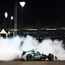 ABU DHABI, UNITED ARAB EMIRATES - NOVEMBER 20: Tenth placed Sebastian Vettel of Germany driving the (5) Aston Martin AMR22 Mercedes performs donuts at the end of his final race during the F1 Grand Prix of Abu Dhabi at Yas Marina Circuit on November 20, 2022 in Abu Dhabi, United Arab Emirates. (Photo by Dan Istitene - Formula 1/Formula 1 via Getty Images)