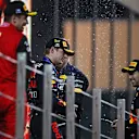ABU DHABI, UNITED ARAB EMIRATES - NOVEMBER 20: Race winner Max Verstappen of the Netherlands and Oracle Red Bull Racing, Second placed Charles Leclerc of Monaco and Ferrari and Third placed Sergio Perez of Mexico and Oracle Red Bull Racing celebrate on the podium during the F1 Grand Prix of Abu Dhabi at Yas Marina Circuit on November 20, 2022 in Abu Dhabi, United Arab Emirates. (Photo by Joe Portlock - Formula 1/Formula 1 via Getty Images)