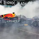 ABU DHABI, UNITED ARAB EMIRATES - NOVEMBER 20: Race winner Max Verstappen of the Netherlands driving the (1) Oracle Red Bull Racing RB18 performs a celebratory donut during the F1 Grand Prix of Abu Dhabi at Yas Marina Circuit on November 20, 2022 in Abu Dhabi, United Arab Emirates. (Photo by Mark Thompson/Getty Images)