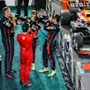 ABU DHABI, UNITED ARAB EMIRATES - NOVEMBER 20: Race winner Max Verstappen of the Netherlands and Oracle Red Bull Racing, second placed Charles Leclerc of Monaco and Ferrari, Olaf Janssen, Red Bull Racing Team Member and Third placed Sergio Perez of Mexico and Oracle Red Bull Racing celebrate on the podium during the F1 Grand Prix of Abu Dhabi at Yas Marina Circuit on November 20, 2022 in Abu Dhabi, United Arab Emirates. (Photo by Bryn Lennon - Formula 1/Formula 1 via Getty Images)