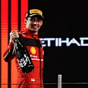 ABU DHABI, UNITED ARAB EMIRATES - NOVEMBER 20: Second placed Charles Leclerc of Monaco and Ferrari celebrates on the podium following the F1 Grand Prix of Abu Dhabi at Yas Marina Circuit on November 20, 2022 in Abu Dhabi, United Arab Emirates. (Photo by Rudy Carezzevoli/Getty Images)