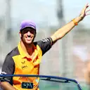 MELBOURNE, AUSTRALIA - APRIL 10: Daniel Ricciardo of Australia and McLaren waves to the crowd on the drivers parade ahead of the F1 Grand Prix of Australia at Melbourne Grand Prix Circuit on April 10, 2022 in Melbourne, Australia. (Photo by Dan Istitene - Formula 1/Formula 1 via Getty Images)