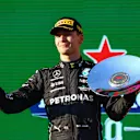 MELBOURNE, AUSTRALIA - APRIL 10: Third placed George Russell of Great Britain and Mercedes celebrates on the podium during the F1 Grand Prix of Australia at Melbourne Grand Prix Circuit on April 10, 2022 in Melbourne, Australia. (Photo by Mark Thompson/Getty Images)