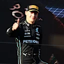 MELBOURNE, AUSTRALIA - APRIL 10: Third placed George Russell of Great Britain and Mercedes celebrates on the podium during the F1 Grand Prix of Australia at Melbourne Grand Prix Circuit on April 10, 2022 in Melbourne, Australia. (Photo by Bryn Lennon - Formula 1/Formula 1 via Getty Images)