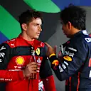 MELBOURNE, AUSTRALIA - APRIL 10: Race winner Charles Leclerc of Monaco and Ferrari and Second placed Sergio Perez of Mexico and Oracle Red Bull Racing talk in parc ferme during the F1 Grand Prix of Australia at Melbourne Grand Prix Circuit on April 10, 2022 in Melbourne, Australia. (Photo by Dan Istitene - Formula 1/Formula 1 via Getty Images)