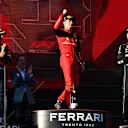 MELBOURNE, AUSTRALIA - APRIL 10: Race winner Charles Leclerc of Monaco and Ferrari celebrates on the podium next to Second placed Sergio Perez of Mexico and Oracle Red Bull Racing and Third placed George Russell of Great Britain and Mercedes during the F1 Grand Prix of Australia at Melbourne Grand Prix Circuit on April 10, 2022 in Melbourne, Australia. (Photo by Bryn Lennon - Formula 1/Formula 1 via Getty Images)