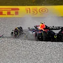 SPIELBERG, AUSTRIA - JULY 10: Sergio Perez of Mexico driving the (11) Oracle Red Bull Racing RB18 runs through the gravel after a collision with George Russell of Great Britain and Mercedes during the F1 Grand Prix of Austria at Red Bull Ring on July 10, 2022 in Spielberg, Austria. (Photo by Rudy Carezzevoli - Formula 1/Formula 1 via Getty Images)