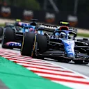 SPIELBERG, AUSTRIA - JULY 10: Nicholas Latifi of Canada driving the (6) Williams FW44 Mercedes leads Fernando Alonso of Spain driving the (14) Alpine F1 A522 Renault during the F1 Grand Prix of Austria at Red Bull Ring on July 10, 2022 in Spielberg, Austria. (Photo by Clive Rose/Getty Images)
