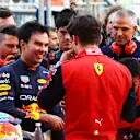 BAKU, AZERBAIJAN - JUNE 11: Second placed qualifier Sergio Perez of Mexico and Oracle Red Bull Racing talks with Pole position qualifier Charles Leclerc of Monaco and Ferrari in parc ferme during qualifying ahead of the F1 Grand Prix of Azerbaijan at Baku City Circuit on June 11, 2022 in Baku, Azerbaijan. (Photo by Mark Thompson/Getty Images)