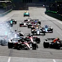 BAKU, AZERBAIJAN - JUNE 12: Sergio Perez of Mexico driving the (11) Oracle Red Bull Racing RB18 leads Charles Leclerc of Monaco driving the (16) Ferrari F1-75 and the rest of the field into turn one at the start during the F1 Grand Prix of Azerbaijan at Baku City Circuit on June 12, 2022 in Baku, Azerbaijan. (Photo by Mark Thompson/Getty Images)