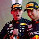 BAKU, AZERBAIJAN - JUNE 12: Race winner Max Verstappen of the Netherlands and Oracle Red Bull Racing and Second placed Sergio Perez of Mexico and Oracle Red Bull Racing celebrate on the podium during the F1 Grand Prix of Azerbaijan at Baku City Circuit on June 12, 2022 in Baku, Azerbaijan. (Photo by Dan Istitene - Formula 1/Formula 1 via Getty Images)