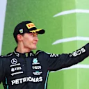 BAKU, AZERBAIJAN - JUNE 12: Third placed George Russell of Great Britain and Mercedes celebrates on the podium during the F1 Grand Prix of Azerbaijan at Baku City Circuit on June 12, 2022 in Baku, Azerbaijan. (Photo by Clive Rose/Getty Images)