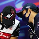 BAHRAIN, BAHRAIN - MARCH 18: Sergio Perez of Mexico and Oracle Red Bull Racing talks with Valtteri Bottas of Finland and Alfa Romeo F1 in the Drivers Press Conference before practice ahead of the F1 Grand Prix of Bahrain at Bahrain International Circuit on March 18, 2022 in Bahrain, Bahrain. (Photo by Clive Rose/Getty Images)