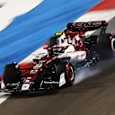 BAHRAIN, BAHRAIN - MARCH 19: Zhou Guanyu of China driving the (24) Alfa Romeo F1 C42 Ferrari locks a wheel under braking during qualifying ahead of the F1 Grand Prix of Bahrain at Bahrain International Circuit on March 19, 2022 in Bahrain, Bahrain. (Photo by Lars Baron/Getty Images)