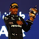 BAHRAIN, BAHRAIN - MARCH 20: Third placed Lewis Hamilton of Great Britain and Mercedes celebrates on the podium during the F1 Grand Prix of Bahrain at Bahrain International Circuit on March 20, 2022 in Bahrain, Bahrain. (Photo by Lars Baron/Getty Images)