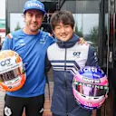 SPA, BELGIUM - AUGUST 27: Fernando Alonso of Alpine F1 and Spain and Yuki Tsunoda of Scuderia AlphaTauri and Japan swap crash helmets during qualifying ahead of the F1 Grand Prix of Belgium at Circuit de Spa-Francorchamps on August 27, 2022 in Spa, Belgium. (Photo by Peter Fox/Getty Images)