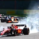 SPA, BELGIUM - AUGUST 28: Carlos Sainz of Spain driving (55) the Ferrari F1-75 locks a wheel under braking ahead of Sergio Perez of Mexico driving the (11) Oracle Red Bull Racing RB18 during the F1 Grand Prix of Belgium at Circuit de Spa-Francorchamps on August 28, 2022 in Spa, Belgium. (Photo by Dan Istitene - Formula 1/Formula 1 via Getty Images)