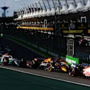 SAO PAULO, BRAZIL - NOVEMBER 12: Kevin Magnussen of Denmark driving the (20) Haas F1 VF-22 Ferrari leads Max Verstappen of the Netherlands driving the (1) Oracle Red Bull Racing RB18 and the rest of the field at the start during the Sprint ahead of the F1 Grand Prix of Brazil at Autodromo Jose Carlos Pace on November 12, 2022 in Sao Paulo, Brazil. (Photo by Mark Thompson/Getty Images)