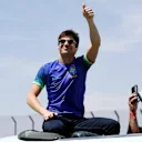 SAO PAULO, BRAZIL - NOVEMBER 13: Lance Stroll of Canada and Aston Martin F1 Team waves to the crowd on the drivers parade prior to the F1 Grand Prix of Brazil at Autodromo Jose Carlos Pace on November 13, 2022 in Sao Paulo, Brazil. (Photo by Jared C. Tilton/Getty Images)