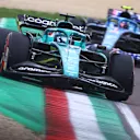 IMOLA, ITALY - APRIL 23: Lance Stroll of Canada driving the (18) Aston Martin AMR22 Mercedes leads Esteban Ocon of France driving the (31) Alpine F1 A522 Renault during Sprint ahead of the F1 Grand Prix of Emilia Romagna at Autodromo Enzo e Dino Ferrari on April 23, 2022 in Imola, Italy. (Photo by Dan Istitene - Formula 1/Formula 1 via Getty Images)