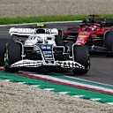 IMOLA, ITALY - APRIL 24: Yuki Tsunoda of Japan driving the (22) Scuderia AlphaTauri AT03 leads Charles Leclerc of Monaco driving (16) the Ferrari F1-75 during the F1 Grand Prix of Emilia Romagna at Autodromo Enzo e Dino Ferrari on April 24, 2022 in Imola, Italy. (Photo by Clive Mason/Getty Images)