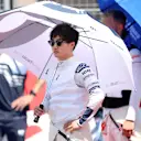 LE CASTELLET, FRANCE - JULY 24: Yuki Tsunoda of Japan and Scuderia AlphaTauri stands for the national anthem on the grid during the F1 Grand Prix of France at Circuit Paul Ricard on July 24, 2022 in Le Castellet, France. (Photo by Peter Fox/Getty Images)