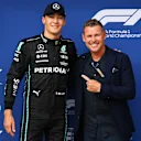 BUDAPEST, HUNGARY - JULY 30: Pole position qualifier George Russell of Great Britain and Mercedes is presented with the Pirelli Pole Position trophy by Tom Kristensen during qualifying ahead of the F1 Grand Prix of Hungary at Hungaroring on July 30, 2022 in Budapest, Hungary. (Photo by Dan Mullan/Getty Images)