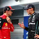 BUDAPEST, HUNGARY - JULY 30: Pole position qualifier George Russell of Great Britain and Mercedes talks with Third placed qualifier Charles Leclerc of Monaco and Ferrari in parc ferme during qualifying ahead of the F1 Grand Prix of Hungary at Hungaroring on July 30, 2022 in Budapest, Hungary. (Photo by Dan Istitene - Formula 1/Formula 1 via Getty Images)