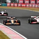 BUDAPEST, HUNGARY - JULY 31: Daniel Ricciardo of Australia driving the (3) McLaren MCL36 Mercedes and Kevin Magnussen of Denmark driving the (20) Haas F1 VF-22 Ferrari battle for track position during the F1 Grand Prix of Hungary at Hungaroring on July 31, 2022 in Budapest, Hungary. (Photo by Dan Mullan/Getty Images)