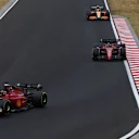 BUDAPEST, HUNGARY - JULY 31: Carlos Sainz of Spain driving (55) the Ferrari F1-75 leads Charles Leclerc of Monaco driving the (16) Ferrari F1-75 during the F1 Grand Prix of Hungary at Hungaroring on July 31, 2022 in Budapest, Hungary. (Photo by Bryn Lennon - Formula 1/Formula 1 via Getty Images)