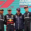 BUDAPEST, HUNGARY - JULY 31: Race winner Max Verstappen of the Netherlands and Oracle Red Bull Racing (second from left), Second placed Lewis Hamilton of Great Britain and Mercedes (L), Third placed George Russell of Great Britain and Mercedes (R) and Adrian Newey, the Chief Technical Officer of Red Bull Racing (second from right) celebrate on the podium during the F1 Grand Prix of Hungary at Hungaroring on July 31, 2022 in Budapest, Hungary. (Photo by Bryn Lennon - Formula 1/Formula 1 via Getty Images)